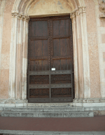 Feeling a little overwhelmed, Janelle poses by a church entrance, Montefalco