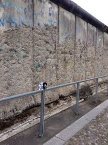 Minions pose beside the Berlin Wall