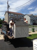 Jeff and Tim wrestling the shelters off the truck